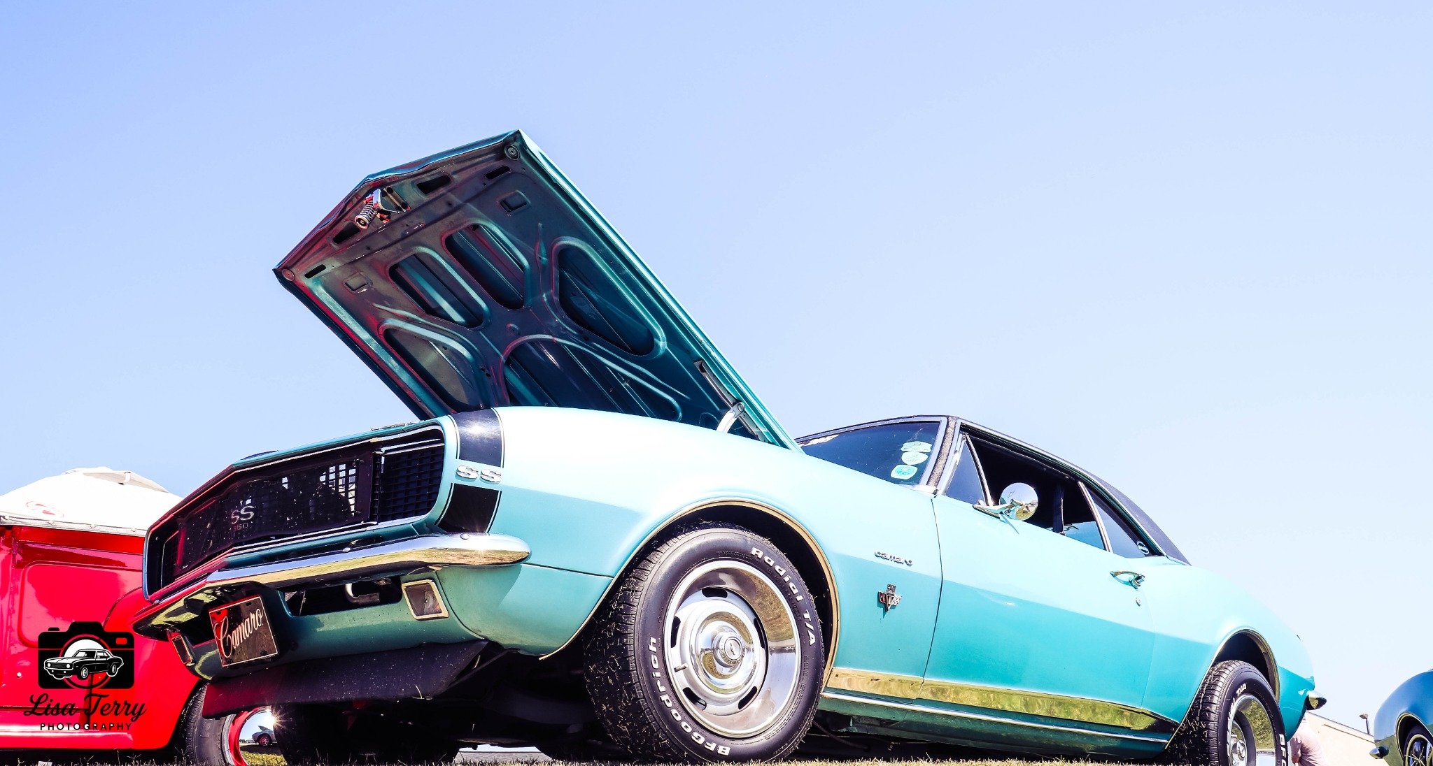 Aqua classic Camaro SS with its hood open