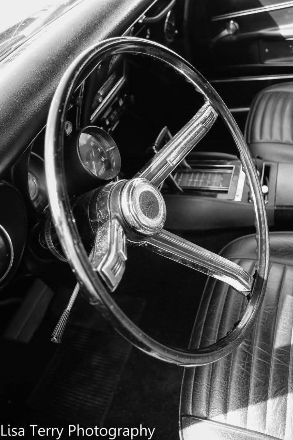 Black-and-white view of the steering wheel and interior of Chris's 1968 Camaro